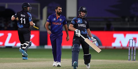 India's Mohammed Shami watches as Namibia's Michael Van Lingen (R) and Stephan Baard run between the wickets. (Photo | AP)