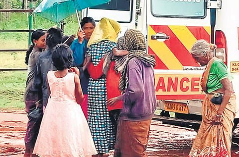 A tribal woman being escorted to an ambulance by fellow villagers. (Photo| EPS)