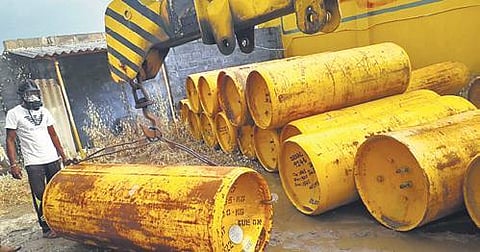 A man in a gas mask moves cylinders at the gas leak site in Erode district  on Saturday, Dec 11, 2021. (Photo | Express)