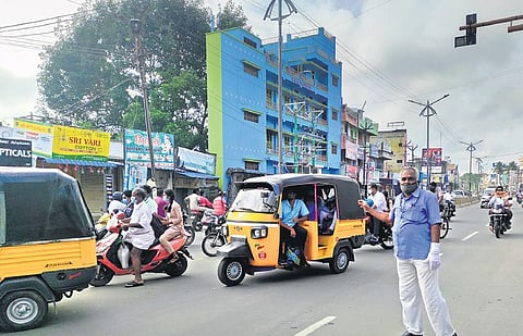 R Madesh showing a demo of his role as a traffic regulator at the Nethaji bypass along the Dharmapuri - Salem road. He has been doing this every day for the past 25 years (Photo | Express)