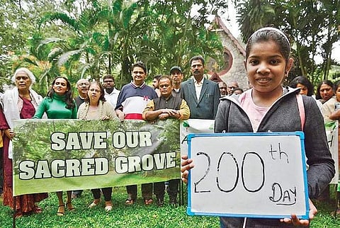Members of All Saints Church protest against BMRCL, asking it to protect  the 150-year-old church, its trees, and urban wildlife, near Vellara  Junction Signal, Hosur Road on Sunday. (Photo | EPS/Shri