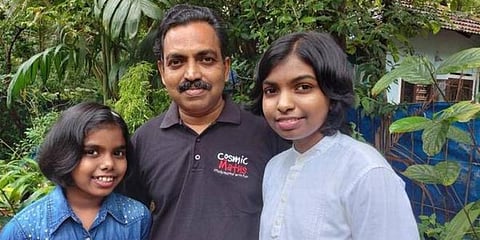 Niveditha D (L) and Nanditha D with their father P Devaraj. (Photo | Special Arrangement)