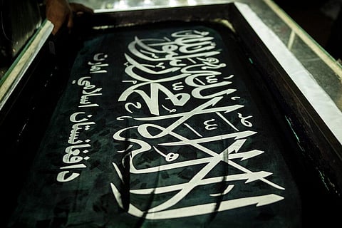 A worker hand prints Taliban flags in a small workshop in Kabul's Jawid market, Afghanistan. (File Photo | AP)