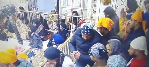 A man with yellow cloth around his head jumped inside the sanctum sanctorum of the Golden Temple. (Video Screengrab)