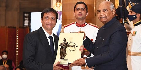 Table tennis coach S Raman receiving award from President Kovind.