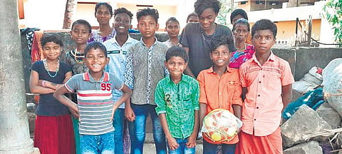 Tribal children are in a joyous mood after receiving sports kits distributed by the society | express