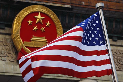 American flag is flown next to the Chinese national emblem during a welcome ceremony for visiting U.S.  (File Photo | AP)
