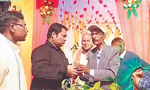 Bholaram Sinha (in white cap) feels his plants are no less than his daughter | express