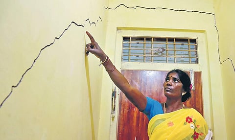 A woman showing cracks on the wall of her house in Vellore (Photo | EPS, S Dinesh)