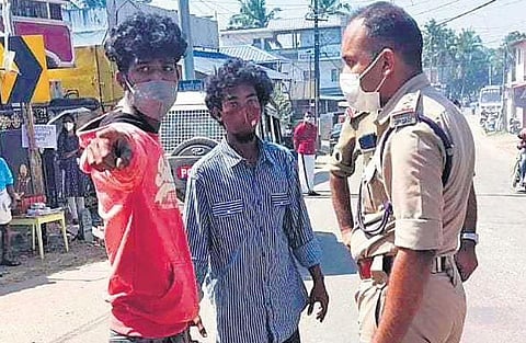 The police bringing Sachin and Gokul, who were accused of hacking Rahul, to Kachani for collecting evidence
