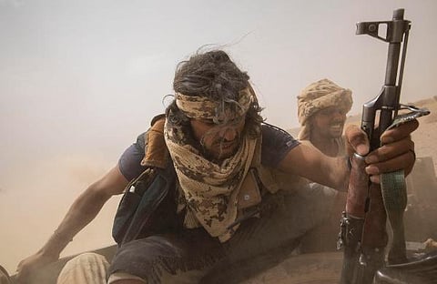 Yemeni fighters backed by the Saudi-led coalition ride on the back of an armored vehicle as they leave the front lines of Marib, Yemen.  (Photo | AP)