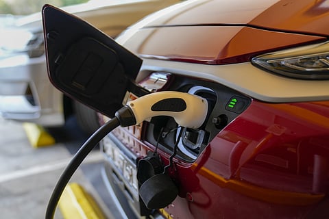 An electric car gets charged at a supermarket carpark. (Representational photo | AP)