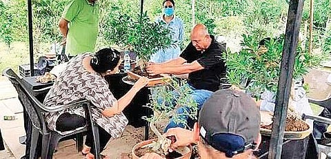Saumik Das (in black) conducting  a bonsai workshop.
