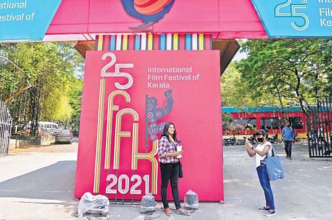 Delegates taking pictures in front of the entrance of Tagore Theatre, which is the main venue of IFFK, on Tuesday | Vincent Pulickal