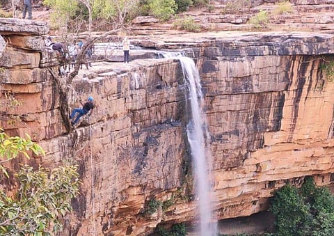 Bastar collector Rajat Bansal roping down a cliff. (Photo | EPS)