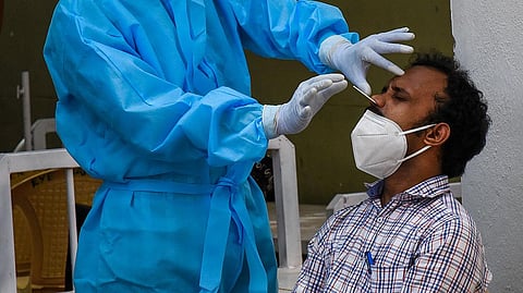 A health worker collects a swab sample from a man to test for the Covid-19 coronavirus. (Photo| M K Ashok Kumar, EPS)