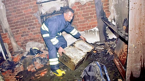 A fire personnel dousing flames at the house in Cuttack  | Express