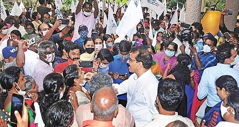 File photo of Twenty-20 founder Sabu Jacob distributing sweets among party workers after winning three more civic bodies while retaining Kizhakkambalam panchayat. (Photo | A Sanesh, EPS)