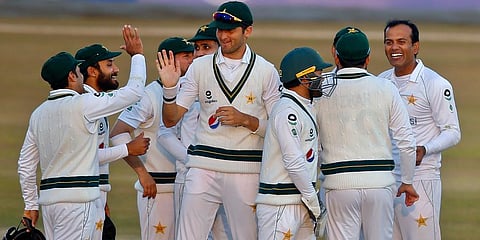 Pakistan's Nauman Ali (R) celebrates with teammates after taking the wicket of South Africa's Aiden Markram during the second day of the second cricket Test match in Rawalpindi. (Photo | AP)