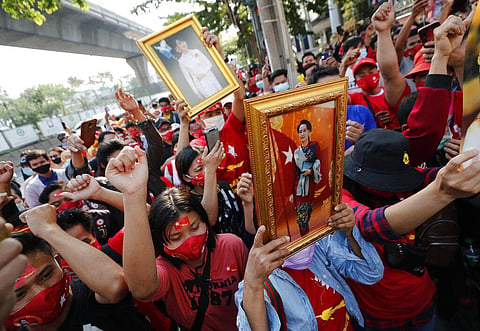 Burmese people living in Thailand hold pictures of Myanmar leader Aung San Suu Kyi during a protest in front of the Myanmar embassy in Bangkok. (Photo | AP)