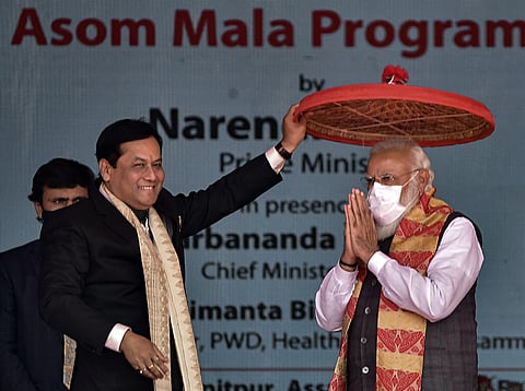 PM Narendra Modi during an event to lay foundation stone of two medical colleges and launch the scheme for the upgradation of the state highways Sonitpur district on Sunday. (Photo | PTI)