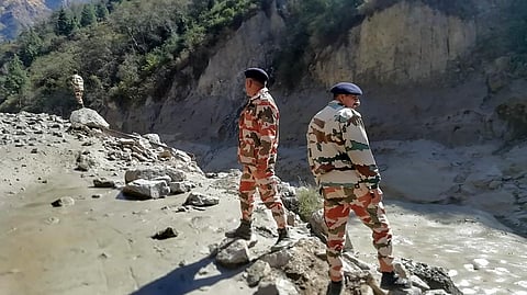 Indo-Tibetan Border Police personnel inspect the area damaged around Tapovan and Reni, after a glacier broke off in Joshimath. (Photo | PTI)