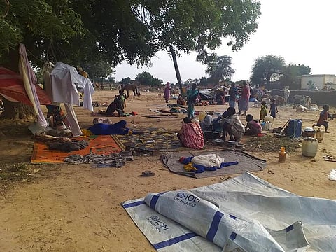 In this July 30, 2020 file photo, residents displaced from a surge of violent attacks squat on blankets and in hastily made tents in the village of Masteri in west Darfur, Sudan.  (Photo | AP)
