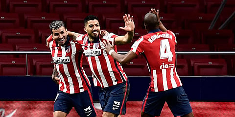 Atletico Madrid's Luis Suarez (C) celebrates with teammates after scoring during a La Ligamatch against Celta at Madrid. (Photo| AP)