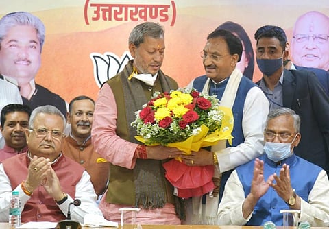 Union Minister and BJP leader Ramesh Pokhriyal Nishank greets party leader Tirath Singh Rawat after being elected as the new Chief Minister of Uttarakhand in Dehradun. (Photo | PTI)