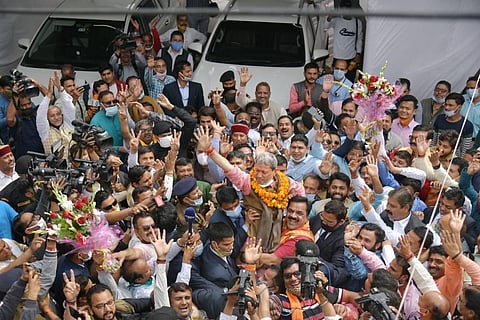Tirath Singh Rawat waves at party workers as he celebrates after being elected as the new Chief Minister of Uttarakhand in Dehradun Wednesday March 10 2021. (Photo | PTI)