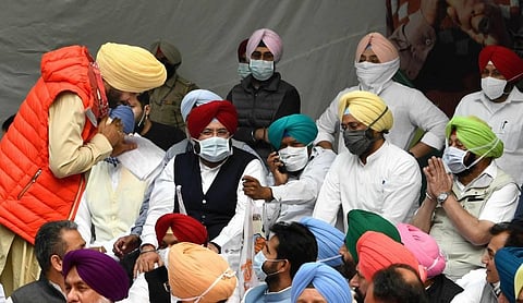Congress leader Navjot Singh Sidhu greets Punjab Chief Minister Capt. Amarinder Singh during a protest against the recent farm reform bills at Jantar Mantar. (File | PTI)