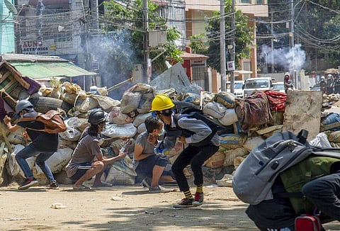 Armed riot policemen charge after firing teargas a rubber bullets as anti-coup protesters abandon their makeshift barricades and run in Yangon, Myanmar Tuesday, March 16, 2021.  (Photo | AP)