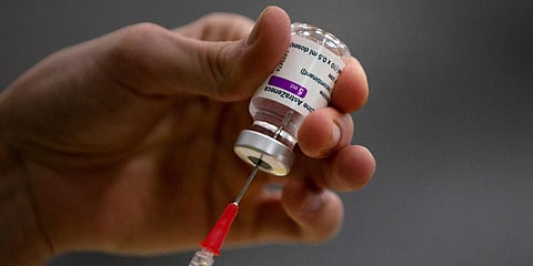 A pharmacist prepares a syringe from a vial of the AstraZeneca coronavirus vaccine during preparations at the Vaccine Village in Antwerp. (File photo| AP)