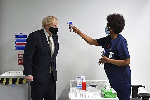 Britain's Prime Minister Boris Johnson has his temperature checked during a visit to Chase Farm Hospital in north London. (File Photo | AP)