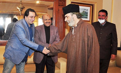 Former Peoples Democratic Party patron Muzaffar Hussain Baig is greeted by J&K People's Conference Chairman Sajad Gani Lone after he joined PC party in Srinagar on  Wednesday. (Photo | PTI)
