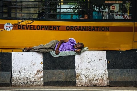 A homeless man sleeping on the sidewalk. (Photo | Pexels.com)