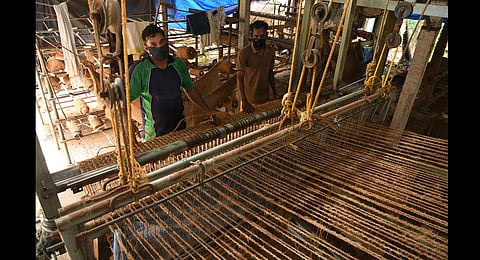 Coir workers Udayan and Saji weaving geotextile mats at a small-scale unit at Kanjikuzhy in Alappuzha. (Photo | Albin Mathew, EPS)