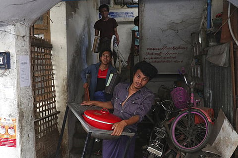 State railway employees carry their belongings after being evicted from their home in Mandalay, Myanmar.  (Photo | AP)
