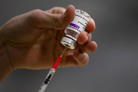 A pharmacist prepares a syringe from a vial of the AstraZeneca coronavirus vaccine  (Photo | AP)