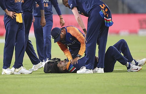 India's Shreyas Iyer, on ground, grimaces in pain after injuring himself while fielding during the first ODI at Pune. (Photo | AP)
