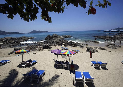 In this March 13, 2014, file photo, tourists spend time on Patong Beach in Phuket province, southern Thailand. (Photo | AP)