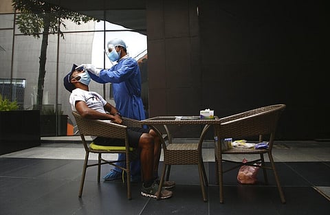 A Nepalese health worker collects a swab sample of a Bahraini expedition team member to test for COVID-19 before heading for an expedition to Mount Everest. (Photo | AP)