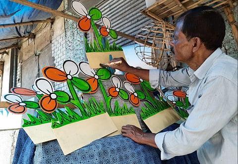 An artist makes party symbols with bamboos & paper at Dompara for an election campaign ahead of assembly elections, in Kolkata. (Photo | ANI)
