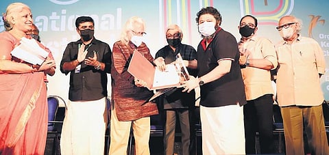 Pellissery receiving the audience award for the best film for ‘Churuli’ from filmmaker Adoor Gopalakrishnan at the valedictory ceremony of 25th International Film Festival of Kerala in Palakkad
