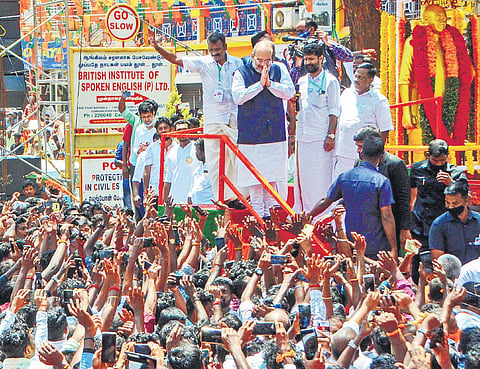Union Minister Amit Shah greets crowd at a road show in Nagercoil on Sunday. (Photo | V Karthikalagu, EPS)
