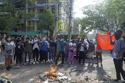 Anti-coup protesters burn constitution books at Tarmwe township in Yangon, Myanmar (Photo | AP)
