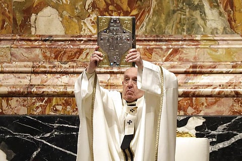 Pope Francis holds up the book of Gospels during a Chrism Mass inside St. Peter's Basilica, at the Vatican (Photo | AP)