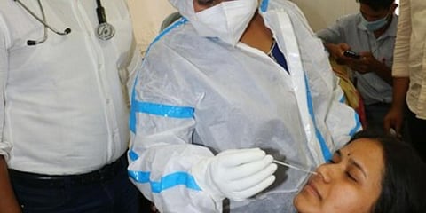 A healthcare worker collects swab sample for covid test. (Photo | EPS)