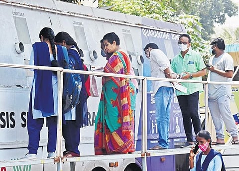 People getting tested for Covid-19 at a mobile lab parked near Vijayawada Railway Station on Wednesday | P Ravindra Babu