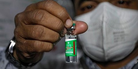 A health worker holds up a Covishield vial. (Photo | EPS)
